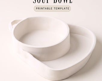 May include: A white ceramic soup bowl with an attached side dish. The bowl has a handle and is labelled "SOUP BOWL PRINTABLE TEMPLATE" in black text.