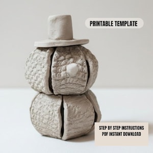 May include: A light grey snowman sculpture with a top hat. The snowman is made of two stacked, textured spheres with a small, round nose. The image includes the text "PRINTABLE TEMPLATE" and "STEP BY STEP INSTRUCTIONS PDF INSTANT DOWNLOAD."