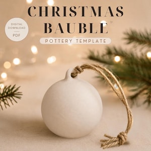 May include: A matte white ceramic Christmas bauble ornament with a smooth, spherical shape and a small top loop. A piece of natural brown jute twine is threaded through the loop and knotted at the end. Text reads CHRISTMAS BAUBLE POTTERY TEMPLATE.