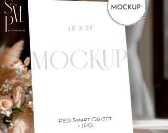 May include: White poster mockup on an easel with the text "MOCKUP" and "18" x "24" printed on it. The poster is blank and ready for your design.