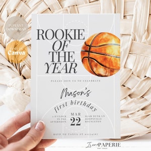 May include: A light grey basketball-themed birthday invitation featuring the text "Rookie of the Year" and a watercolour basketball illustration. The invitation includes details for a first birthday celebration, with the date March 22.
