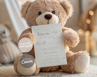May include: A light brown plush teddy bear holding a white rectangular gender reveal invitation card. The card features the text A little piece of heaven is on the way, he or she, and includes details for a party for Melanie and Brian.