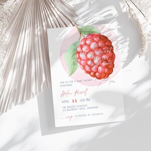 May include: Baby shower invitation featuring a watercolor raspberry illustration. The text reads "a berry sweet BABY is on the way!" with details for the event, including the honoree's name, date, time, and location.