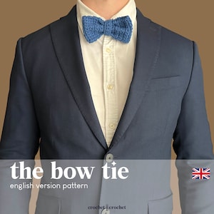Peut inclure: Un nœud papillon bleu crocheté porté par une personne vêtue d'une veste de costume bleu marine et d'une chemise blanche. Le texte "the bow tie" et "english version pattern" est sous l'image.