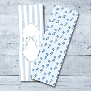May include: Two printable bookmark designs. The first design features blue and white stripes with a white frame and a blue bow. The second design features a light blue background with a repeating pattern of blue flowers.