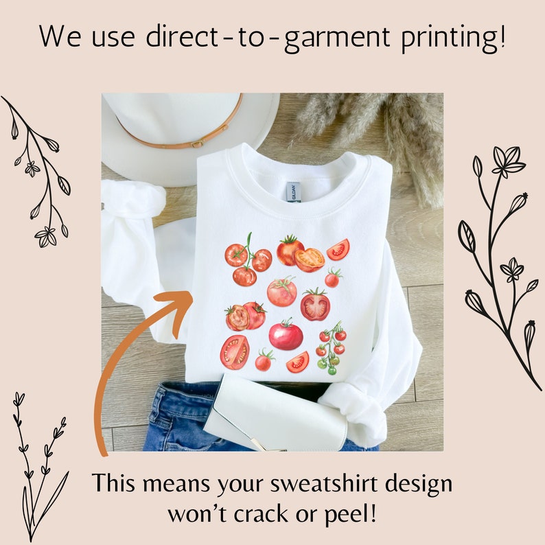 May include: White sweatshirt with a red tomato design. The text "We use direct-to-garment printing!" is at the top of the image. The text "This means your sweatshirt design won't crack or peel!" is at the bottom of the image.