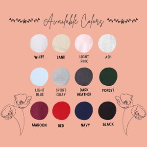 May include: A chart showing 12 different color options for a product. The colors are: white, sand, light pink, ash, light blue, sport gray, dark heather, forest, maroon, red, navy, and black.