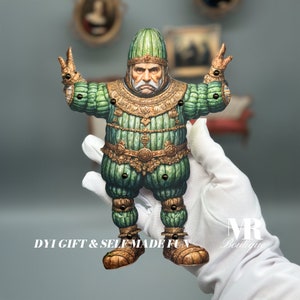 May include: A green and gold puppet of a man with a large, round head and a long, white beard. The puppet is wearing a green and gold costume with a large, round collar. The puppet is holding its arms out to the sides, as if it is about to dance. DIY GIFT & SELF MADE FUN is written on the bottom of the image.