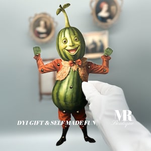 May include: A green and brown puppet shaped like a gourd with a smiling face, wearing a red and gold costume with a bow tie. The puppet has movable arms and legs. The text "DIY GIFT & SELF MADE FUN" is printed below the puppet.