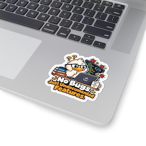 May include: A die-cut sticker featuring a cartoon duck wearing glasses, sitting at a laptop with code on the screen, surrounded by books and small red bugs. The text reads: No Bugs, Just Undocumented Features, and Trust The Process on a mug.