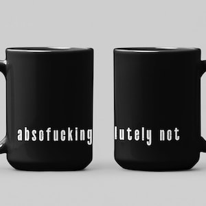 May include: Two black ceramic mugs with white text. One mug reads "absofucking" and the other reads "lutely not". The mugs have a curved handle and a glossy finish. The mugs are displayed on a light gray background.