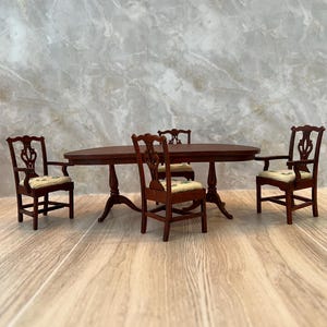 1 12 scale Dark Walnut Dining Set. The set includes 4 chairs. It’s perfect for a little larger Dining Room. The chair cushions are hand wove