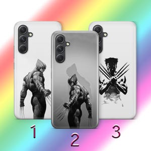 May include: Three phone cases with different designs featuring a black and white illustration of a superhero. The cases are white with black accents and have a camera cutout.