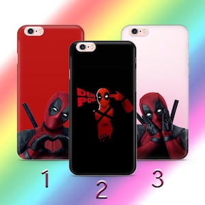May include: Three different phone cases featuring the Marvel Comics character Deadpool. The first case is red with Deadpool making a heart shape with his hands. The second case is black with Deadpool pointing a gun to his head. The third case is pink with Deadpool covering his eyes with his hands. All three cases have the text "Deadpool" on them.