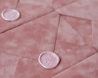 May include: Pink envelopes with a pink wax seal with a floral design.
