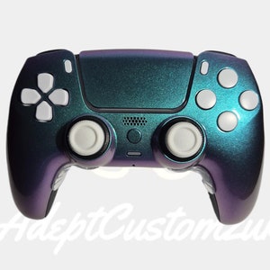 May include: A teal and purple iridescent PlayStation 5 controller with white buttons and face buttons. The controller has a textured finish.