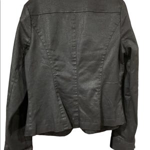May include: Rear view of a dark grey blazer. The jacket has a textured finish and a tailored cut. It features a notched collar, long sleeves, and a single-button fastening. The back has a central seam and princess seams for shaping.