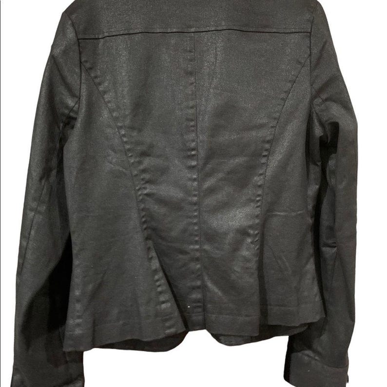 May include: Rear view of a dark grey blazer. The jacket has a textured finish and a tailored cut. It features a notched collar, long sleeves, and a single-button fastening. The back has a central seam and princess seams for shaping.