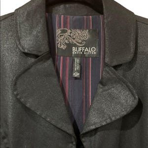 May include: A black jacket with a textured finish. The interior lining features a striped pattern in navy, red, and white. The label reads "BUFFALO DAVID BITTON."