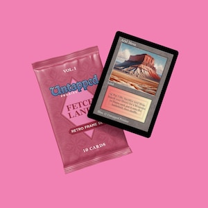 May include: A pink Untapped Proxies Fetch Land Retro Frame Set card pack with the text "VOL. 1" and "10 CARDS". Next to it is an Arid Mesa card with a desert landscape image.