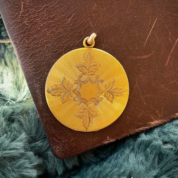 Vintage gold filled circle locket with engraved leaf design