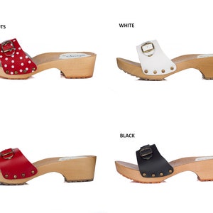 May include: Four pairs of wooden platform clogs with a buckle closure. The clogs are available in red with white polka dots, white, red, and black.