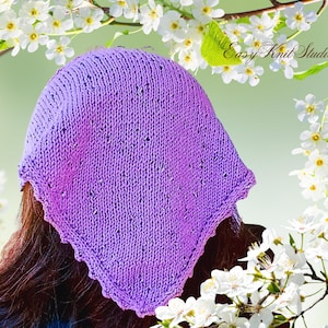 May include: A hand-knitted purple head covering with a scalloped edge. The head covering is a solid color with small dark flecks throughout. The background features white flowers and the text "Easy Knit Studio".
