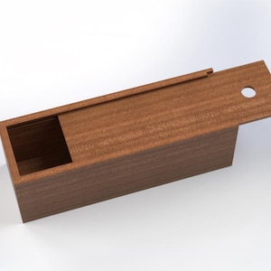 May include: A rectangular wooden box with a sliding lid. The box is made of a reddish-brown wood and has a smooth finish. The lid is partially open, revealing the interior of the box. A small circular hole is in the lid.