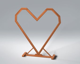 May include: A wooden heart-shaped decorative stand. The stand is made of light brown wood and features a geometric design. The heart shape is open in the center and supported by a base with two legs.