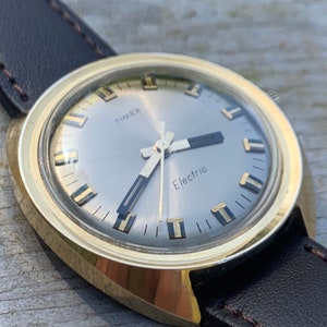 Space Age Timex - Pristine Early 70s Pre-Quartz Electric Watch, Large Goldtone w/radiant Dial. Excellent Condition with New Leather Strap