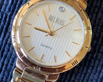 Classic Bill Blass Quartz Watch - Elegant Striped Dial with Roman Bezel, Goldtone, Excellent Condition, Integral Bracelet, Slim, All links.