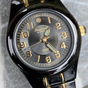 Precision by Gruen Women&#39;s Quartz Watch Two Tone Dark Steel and Gold.  Radiant Dial. Barely worn, new battery, runs well. 6.25&quot;