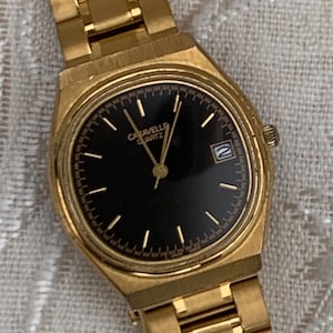 Worn 1992 Caravelle Cushion Quartz Watch by Bolova Gold Tone Finish, Black Dial with Date, New battery. New Bracelet. Presentable.