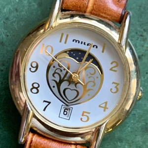 Milan Moon Phase Watch - Women's True Moonphase with Heart Shape Dial:  New battery, new light brown leather strap. Illustrated Dial. Date.