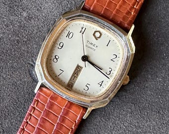 1980-ish Timex Square "Q" Quartz Watch. Gold Tone with Cream Dial with Vertical Day/Date. New Lizard Strap, New Battery. Retro Classic.