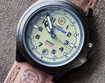 Women's Timex Expedition Indiglo Field Watch – Textured Wave Dial, Black Matte Case, Original Leather and Nubuck Strap. Lightly worn.
