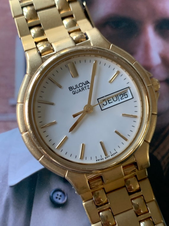 1988 Bulova Quartz Watch Gold Tone Finish, White Dial With Day 