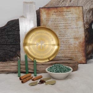 May include: A golden ritual plate with engraved text and symbols, surrounded by green candles, cinnamon sticks, and a bowl of green herbs. A handwritten paper with text is in the background, along with a large piece of selenite.