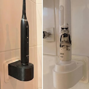 May include: Two electric toothbrushes, one black and one white, mounted on wall chargers. The black toothbrush has a sleek design with the "Oral-B iO" logo. The white toothbrush features a Stormtrooper graphic. Both are plugged into wall sockets.