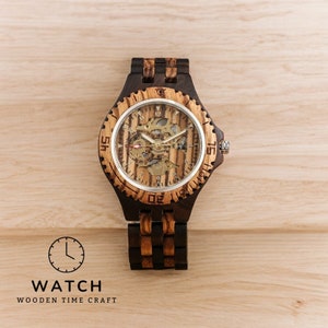 Gold-toned automatic men watch with Arabic numerals on a full wood bracelet and case. Eco-friendly, self-winding wristwatch with a clear analog display.