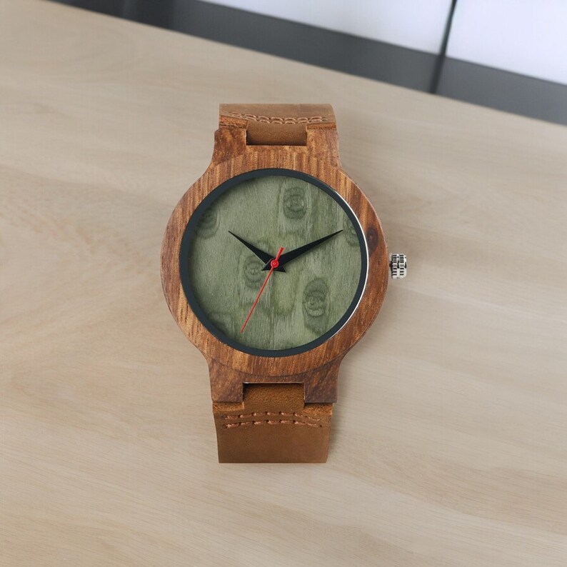 Stylish minimalist wristwatch featuring a wood case with a choice of black, brown, or green dial, complemented by a genuine leather strap. Ideal for both men and women, perfect as a gift.