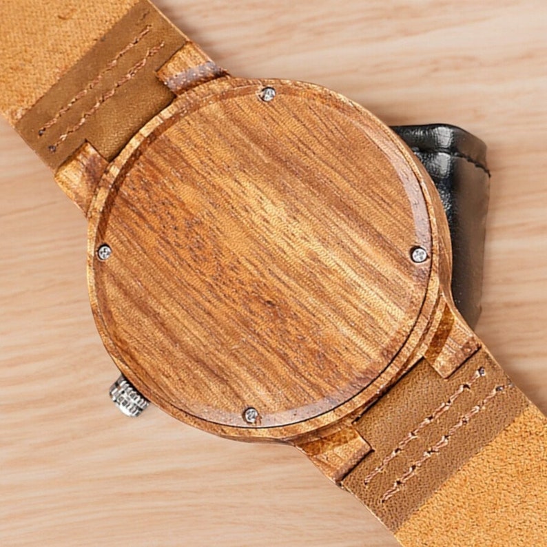 Stylish minimalist wristwatch featuring a wood case with a choice of black, brown, or green dial, complemented by a genuine leather strap. Ideal for both men and women, perfect as a gift.