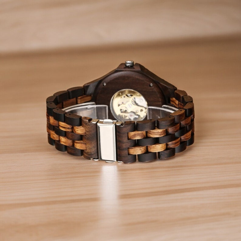 Gold-toned automatic men watch with Arabic numerals on a full wood bracelet and case. Eco-friendly, self-winding wristwatch with a clear analog display.