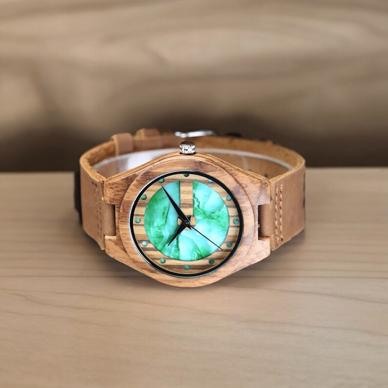 Stylish men wristwatch featuring a unique white and green display, set in zebrawood casing with a quartz movement. Paired with a brown genuine leather strap, this casual yet fashionable accessory complements any outfit.