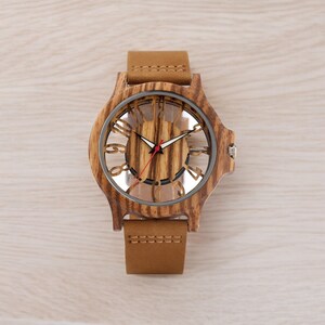 Men chic fashion quartz watch featuring a transparent hollow display with Arabic numerals on a wooden case, complemented by a genuine leather strap.