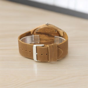 Men quartz wristwatch with a unique wooden design, showcasing annual rings and block points on the face, paired with black hands. Features a brown genuine leather strap and is ideal for sports and casual wear.