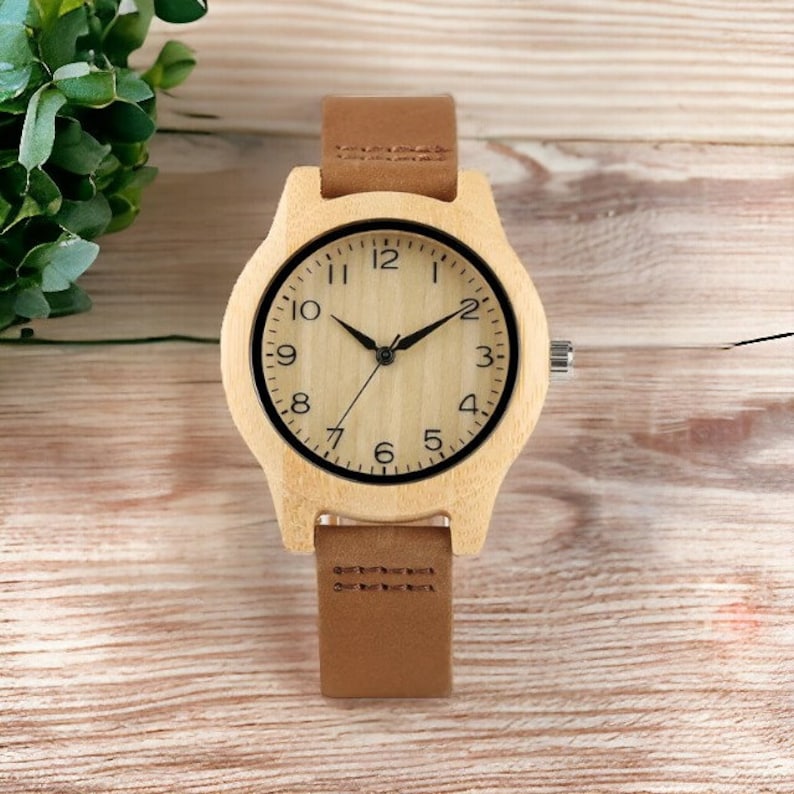 Elegant bamboo wooden ladies bracelet watch with a soft leather band, showcasing a simple yet casual design. Ideal as a gift for women.