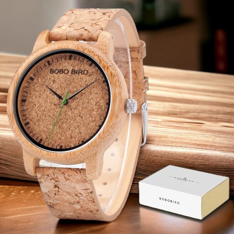 Pair of elegant wooden wristwatches with cork straps, presented in a luxury box. The bamboo watch face features a custom logo, making it a unique gift for couples. Handcrafted with attention to detail.