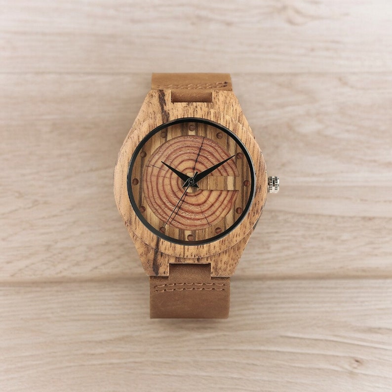 Men quartz wristwatch with a unique wooden design, showcasing annual rings and block points on the face, paired with black hands. Features a brown genuine leather strap and is ideal for sports and casual wear.