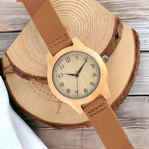 Elegant bamboo wooden ladies bracelet watch with a soft leather band, showcasing a simple yet casual design. Ideal as a gift for women.